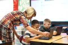 A West Virginia teacher helps a pupil. (Photo credit: MICHAEL MATHES/AFP via Getty Images)