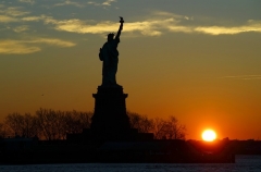 The sun rises behind the Statue of Liberty in New York City on January 21, 2021 as seen from Jersey City, New Jersey. (Photo by Gary Hershorn/Getty Images)