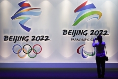 A visitor in Beijing takes pictures of logos for the 2022 Winter Olympic Games. (Photo by Wang Zhao/AFP via Getty Images)