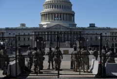 Members of the National Guard watch a checkpoint on Capitol Hill on March 5, 2021, in Washington, DC. (Photo by OLIVIER DOULIERY/AFP via Getty Images)