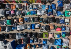 Aerial view of a migrants camp where asylum seekers wait for US authorities to allow them to start their migration process outside El Chaparral crossing port in Tijuana, Baja California state, Mexico on March 17, 2021. (Photo by GUILLERMO ARIAS/AFP via Getty Images)