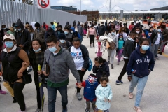 Migrants and asylum seekers awl after a demonstration at the San Ysidro crossing port asking US authorities to allow them to start their migration process in Tijuana, Baja California state, Mexico on March 23, 2021. (Photo by GUILLERMO ARIAS/AFP via Getty Images)