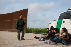 - A Border Patrol agent apprehends illegal immigrants shortly after they crossed the border from Mexico into the United States on Monday, March 26, 2018 in the Rio Grande Valley Sector near McAllen, Texas. (Photo by LOREN ELLIOTT/AFP via Getty Images)