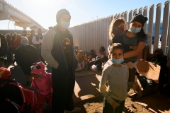 Asylum seekers from countries including Honduras wait to cross into the United States in Tijuana, Mexico on February 19, 2021. (Photo by PATRICK T. FALLON/AFP via Getty Images)