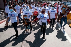 Foreigners wear "Biden, please let us in" T-shirts on their way to the Southwest border in Tijuana, Mexico on March 2, 2021. (Photo by GUILLERMO ARIAS/AFP via Getty Images)