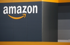 The logo of Amazon is seen on the facade of the company logistics center. (Photo credit: Chesnot/Getty Images)