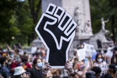 A protester holds a Black Lives Matter fist after George Floyd's death. (Photo credit: Ira L. Black/Corbis via Getty Images)