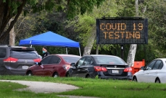 - A police officer mans the entrance to a coronavirus (COVID-19) testing center in Hansen Dam Park on March 25, 2020 in Pacoima, California. (Photo by FREDERIC J. BROWN/AFP via Getty Images)