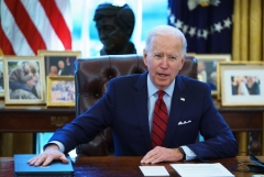 S President Joe Biden speaks before signing executive orders on health care, in the Oval Office of the White House in Washington, DC, on January 28, 2021. - The orders include reopening enrollment in the federal Affordable Care Act. (Photo by MANDEL NGAN/AFP via Getty Images)