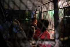 In a photo taken on March 27, 2021 two unaccompanied seven year-old child immigrants who arrived illegally across the Rio Grande river from Mexico stand at a makeshift processing checkpoint before being detained at a holding facility by border patrol agents in the border city of Roma. (Photo by ED JONES/AFP via Getty Images)