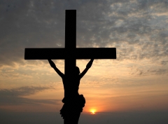 Featured is the silhouette of a depiction of Jesus on the cross. (Photo credit: NOAH SEELAM/AFP via Getty Images)