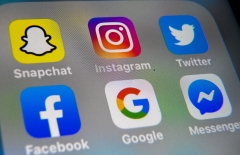 Featured are the logos of several Big Tech and social media apps. (Photo credit: DENIS CHARLET/AFP via Getty Images)