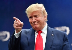 President Donald Trump points to a member of the crowd. (Photo credit: NICHOLAS KAMM-AFP via Getty Images)