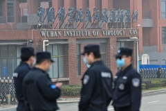 Security personnel stand guard outside the Wuhan Institute of Virology in Wuhan as members of the World Health Organization (WHO) team investigating the origins of the COVID-19 coronavirus make a visit to the institute in Wuhan in China's central Hubei province on February 3, 2021. (Photo by HECTOR RETAMAL/AFP via Getty Images)