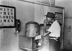 A black man drinks at a segregated water fountain during the Jim Crow era. (Photo credit: Bettmann/Contributor/Getty Images)