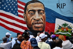 Featured is Kenny Altidor's mural depicting George Floyd. (Photo credit: ANGELA WEISS/AFP via Getty Images)