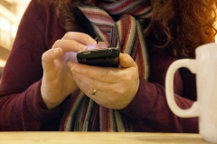 A woman uses a cell phone. (Photo credit: Tracy Packer/Contributor/Moment Mobile ED/Getty Images)