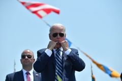 President Joe Biden uses his fingers to whistle during the US Coast Guard Academys 140th commencement exercises on May 19, 2021 in New London, Connecticut. (Photo by NICHOLAS KAMM/AFP via Getty Images)