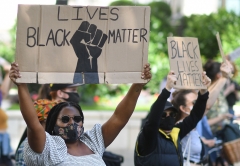 Individuals participate in a Black Lives Matter protest. (Photo credit: JUSTIN TALLIS/AFP via Getty Images)