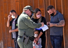  Migrants attempting to cross in to the U.S. from Mexico are detained by U.S. Customs and Border Protection at the border May 21, 2021 in San Luis, Arizona. (Photo by Nick Ut/Getty Images)