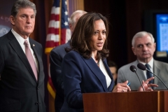 Kamala Harris, now the vice president, joins Sen. Joe Manchin (D-W.Va.) at a press conference in 2018. (Photo by NICHOLAS KAMM/AFP via Getty Images)