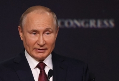 Russian President Vladimir Putin gives a speech at the International Economic Forum in Saint Petersburg on Friday. (Photo by Mikhail Svetlov/Getty Images)