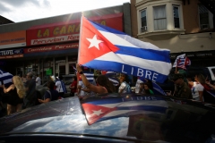 People wave Cuban flags as they drive down a road during a protest showing support for Cubans demonstrating against their government, in Union City, New Jersey, on July 18, 2021. (Photo credit: KENA BETANCUR/AFP via Getty Images)