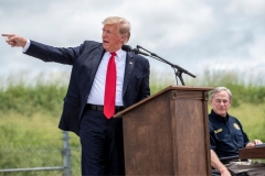 Former US president Donald Trump gestures as he speaks, flanked by Texas Governor Greg Abbott, during a visit to the border wall near Pharr, Texas on June 30, 2021. - Former President Donald Trump visited the area with Texas Gov. Greg Abbott to address the surge of unauthorized border crossings that they blame on the Biden administration's change in policies. (Photo by SERGIO FLORES/AFP via Getty Images)