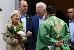 President Joe Biden (C) and First Lady Jill Biden (L) speak with a priest as they leave St. Joseph on the Brandywine Catholic Church in Wilmington, Del. (Photo credit: OLIVIER DOULIERY/AFP via Getty Images)