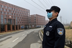 A security guard stands near the Wuhan Institute of Virology in Wuhan, a facility at the center of controversy over the theory that the coronarivus may have leaked accidentally from a lab. (Photo by Hector Retamal/AFP via Getty Images)