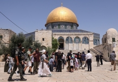 With the Dome in the Rock mosque in the background, Jewish visitors enter the Temple Mount compound in Jerusalem on Sunday, a fasting day marking the destruction of ancient Jewish temples. (Photo by Ahmad Gharabli/AFP via Getty Images)