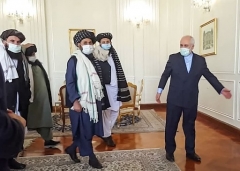 Iranian foreign minister Javad Zarif welcomes a senior Taliban delegation on a previous visit to Tehran, last January. (Photo by -/Tasnim News/AFP via Getty Images)