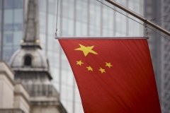 The Chinese flag hangs from a building. (Photo credit: In Pictures Ltd./Corbis via Getty Images)