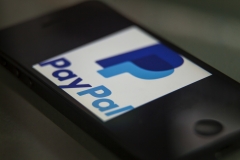 PayPal's logo is featured on a phone. (Photo credit: Ted Soqui/Corbis via Getty Images)