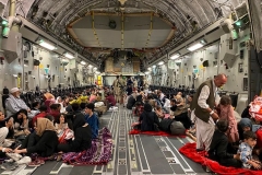 Afghan people board a U.s. military aircraft to leave Afghanistan on August 19, 2021 after the Taliban's takeover of Afghanistan. (Photo by SHAKIB RAHMANI/AFP via Getty Images)