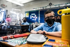 Students wear facemasks as they attend their first day of school at the St. Lawrence Catholic School in Miami on August 18, 2021. (Photo by CHANDAN KHANNA/AFP via Getty Images)