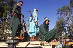 In this picture taken on August 13, 2021, Taliban fighters stand on a vehicle along the roadside in Herat, Afghanistan's third biggest city, after government forces pulled out the day before. (Photo by AFP via Getty Images)