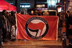 Antifa activists stand with a banner. (Photo credit: ZAKARIA ABDELKAFI/AFP via Getty Images)