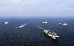 A Chinese aircraft carrier sails ahead of other Chinese ships during a drill in the East China Sea. (Photo by AFP via Getty Images)