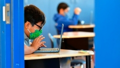 COVID has produced a new normal for masked school children. (Photo by FREDERIC J. BROWN/AFP via Getty Images)