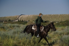 A United States Border Patrol Agent patrols on horseback on the U.S.-Mexico border in Sunland Park, New Mexico on September 9, 2021. (Photo by PAUL RATJE/AFP via Getty Images)