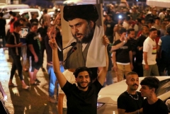 Supporters of Moqtada al-Sadr celebrate the interim election results in Baghdad's Tahrir square. (Photo by Ahmad al-Rubaye/AFP via Getty Images)