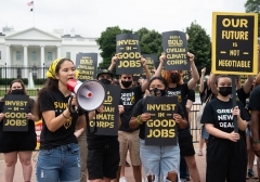 Sunrise Movement climate activists protest in front of the White House in June. (Photo by Saul Loeb/AFP via Getty Images)