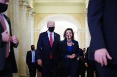 President Joe Biden walks with House Speaker Nancy Pelosi after a caucus meeting at the Capitol on October 1, 2021. (Photo by MANDEL NGAN/AFP via Getty Images)