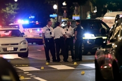 Police officers work at the scene of a shooting outside a restaurant in Washington, DC, on July 22, 2021. (Photo by BRENDAN SMIALOWSKI/AFP via Getty Images)
