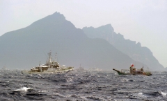 A Taiwan fishing boat is blocked by a Japan Coast Guard vessel near the disputed Diaoyu/Senkaku islands in the East China Sea on September 25, 2012. (Photo by SAM YEH/AFP/GettyImages)