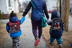 A mother walks two children home from daycare in Burlington, Vt. (Photo by Robert Nickelsberg/Getty Images)