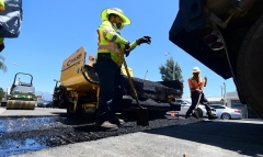 A road resurfacing project in Alhambra, California. (Photo by FREDERIC J. BROWN/AFP via Getty Images)