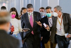 Senator Joe Manchin (D-W.Va.) is surrounded by reporters asking if he'll vote for Joe Biden's Build Back Better Act, on Nov. 2, 2021. (Photo by MANDEL NGAN/AFP via Getty Images)