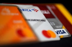 This illustration picture shows debit and credit cards arranged on a desk on April 6, 2020 in Arlington, Va. (Photo credit: OLIVIER DOULIERY/AFP via Getty Images)